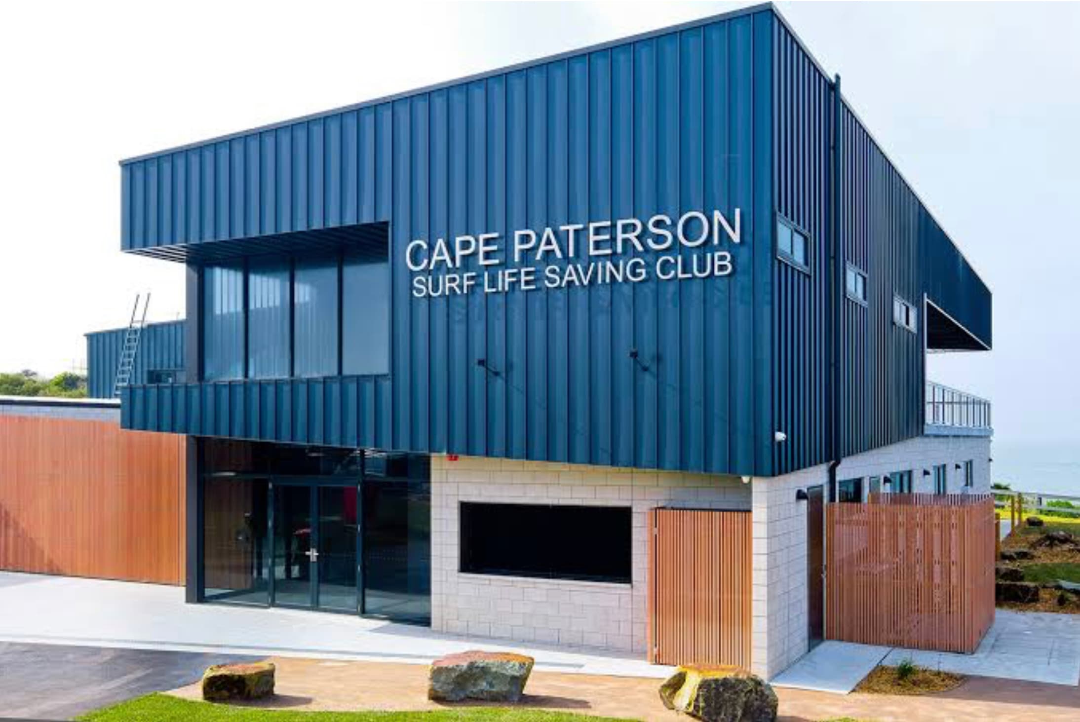 Team in front of club house posing for a photo for pink zinc day