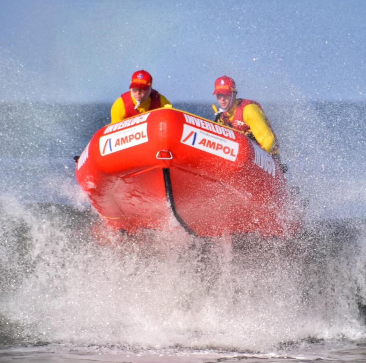 Inflatable rescue boat jumping a wave